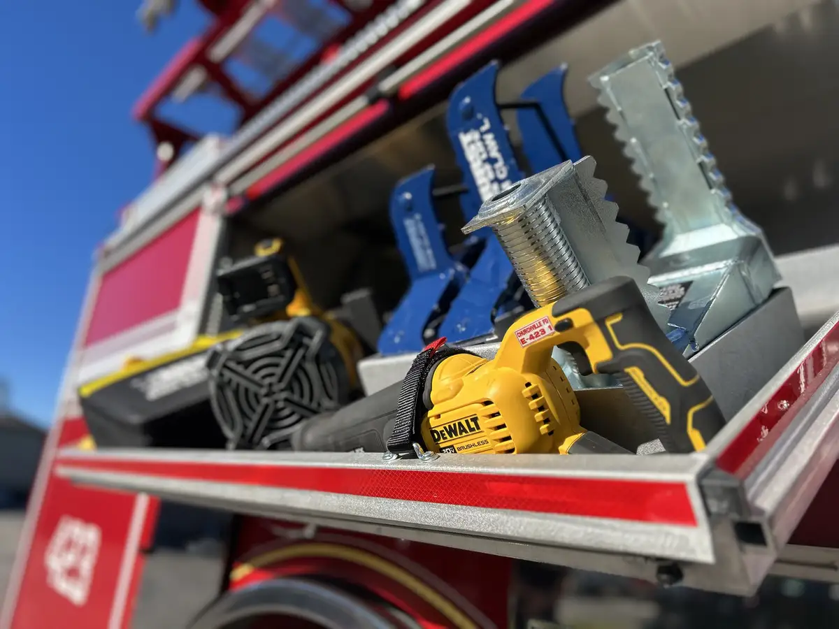 Tool tray close-up showing battery rescue tools and carrying case