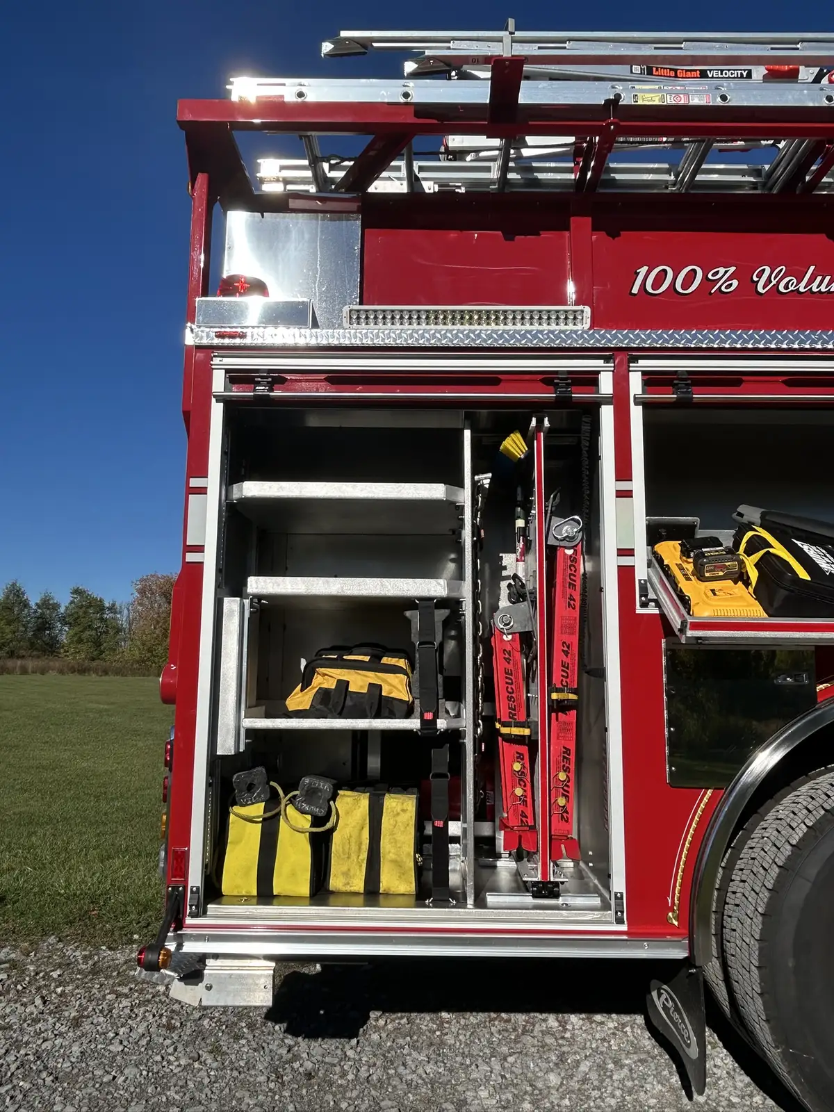 Rear center compartment open showing stacked equipment bags and chevron frame