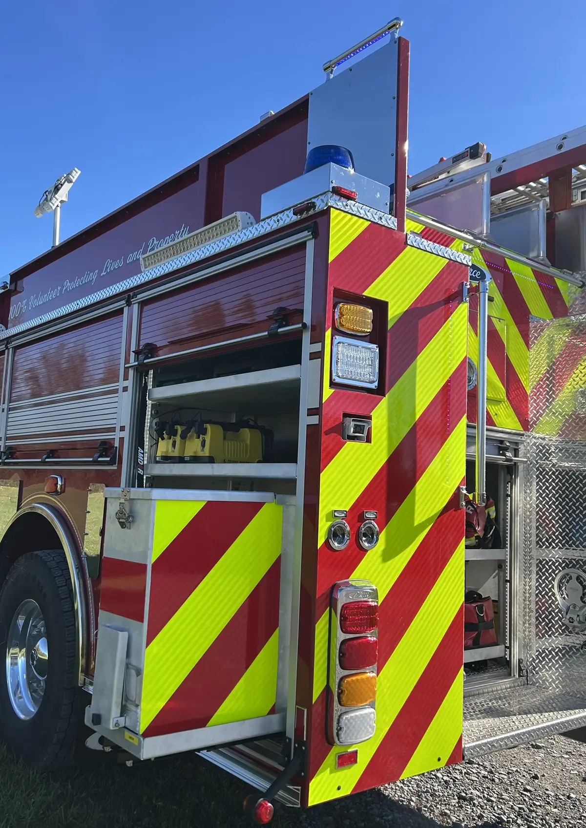 Officer-side compartment open showing water can and mounted equipment