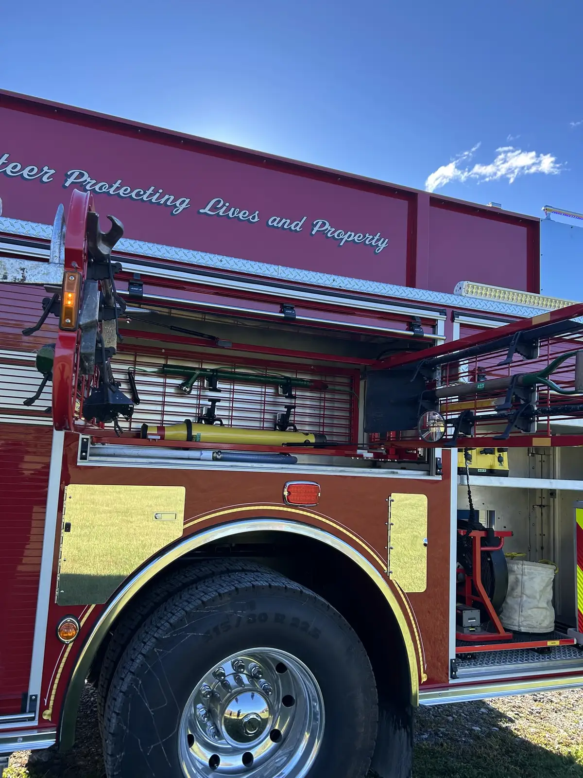 Open side compartment with saws, hose fittings, and utility equipment