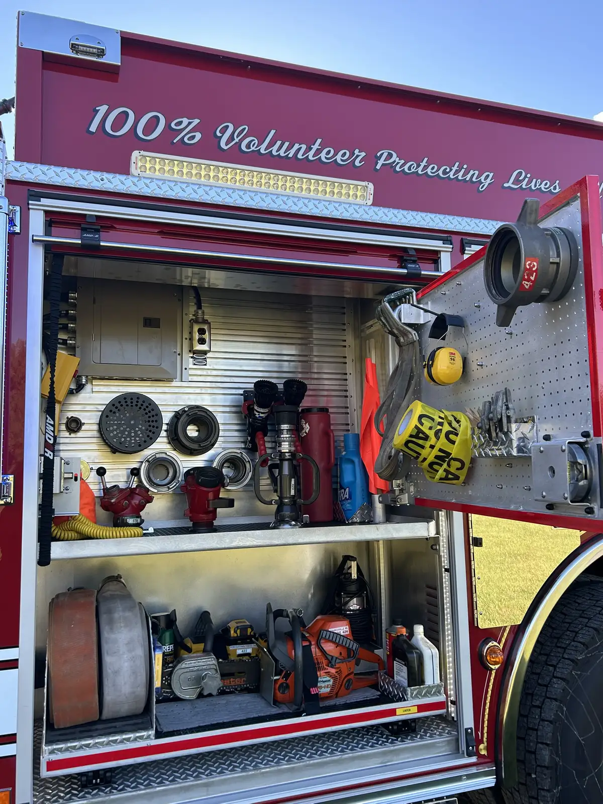 Cab interior center console view with mounted flashlights and control levers