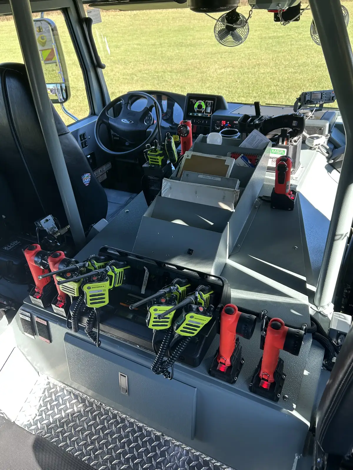 Cab interior controls close-up showing flashlights, switches, and workstation layout