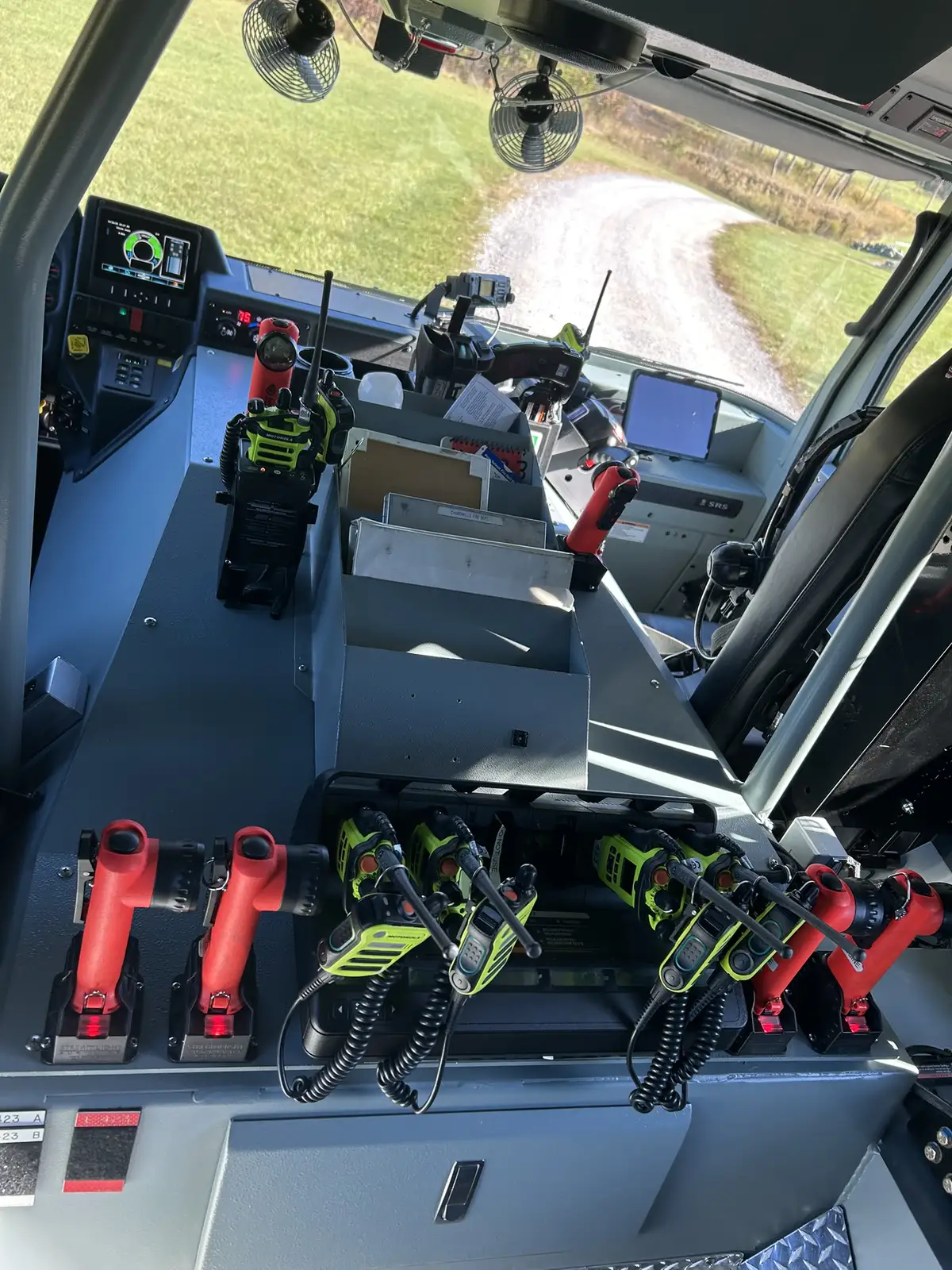 Driver console close-up with joystick controls, display, and cup holders