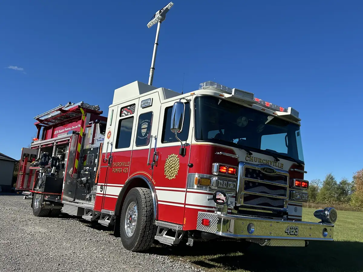 Pierce pumper front-right profile view with grille and side compartments
