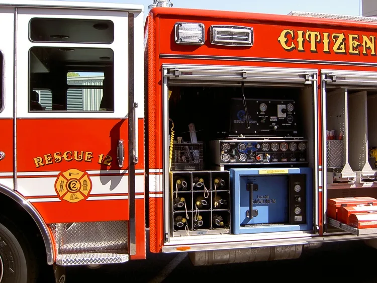 Open side compartment showing portable generator and equipment bins