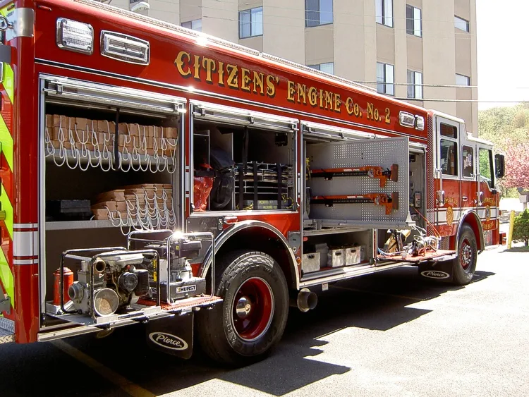 Driver-side profile showing pumper body and side compartments