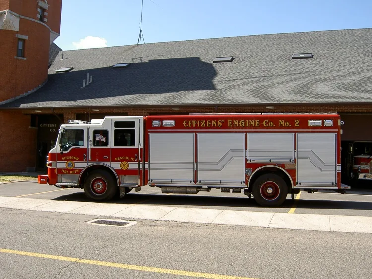Driver-side full profile view parked alongside station wall