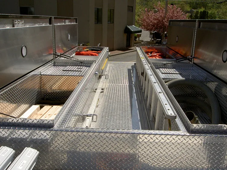 Top deck close-up showing hosebed tray rails and walkway panels