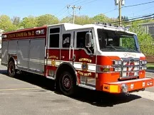 Pumper front-left exterior view showing cab and side body parked outside