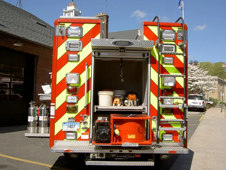 Rear view showing red-and-yellow chevrons with open rear center compartment