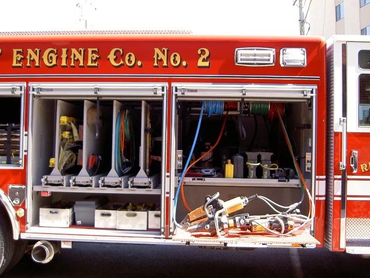 Open side compartment showing mounted hand tools and equipment shelves