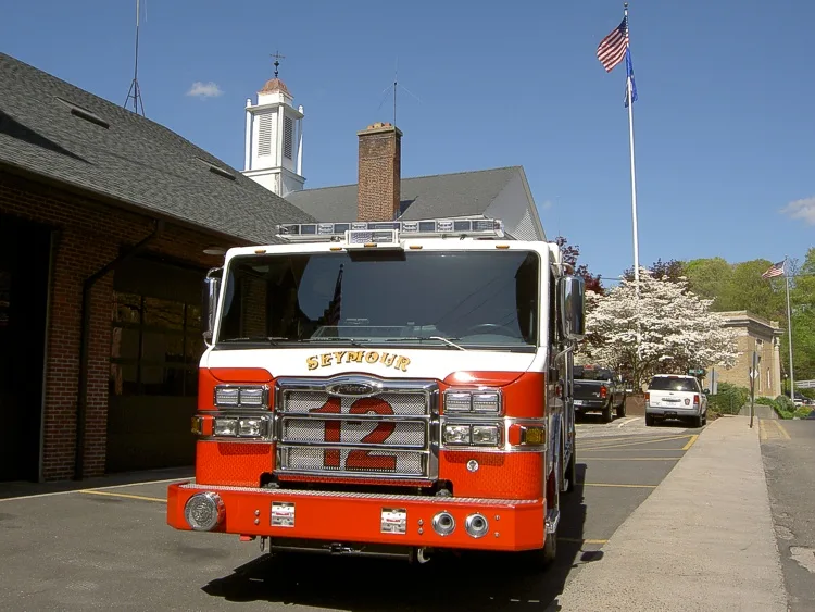 Head-on front view showing grille, bumper, and warning lights