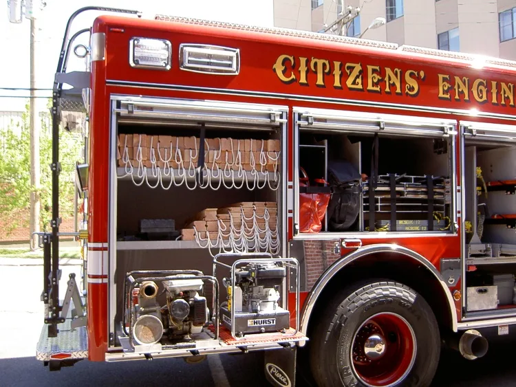 Driver-side profile with side compartment open showing pump-side storage