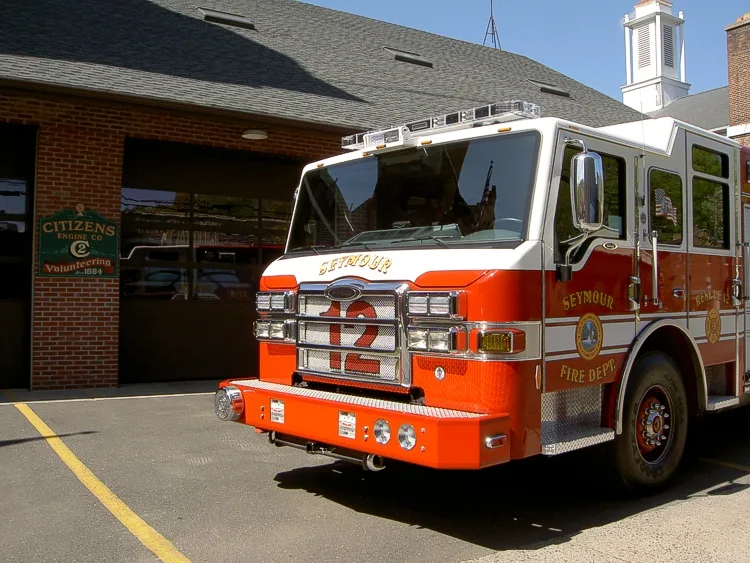 Front-left close exterior view showing cab corner and grille