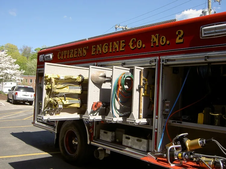Open long side compartment showing assorted tools and shelf organization
