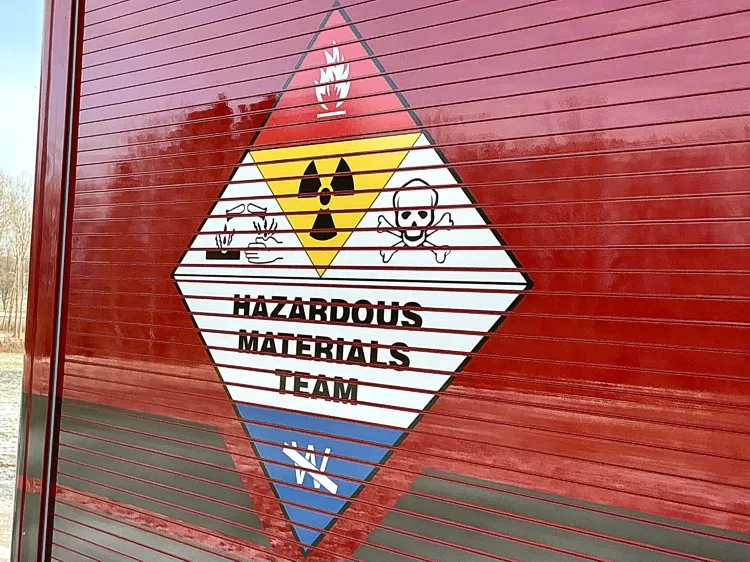 Maltese cross style crest decal close-up on red body panel