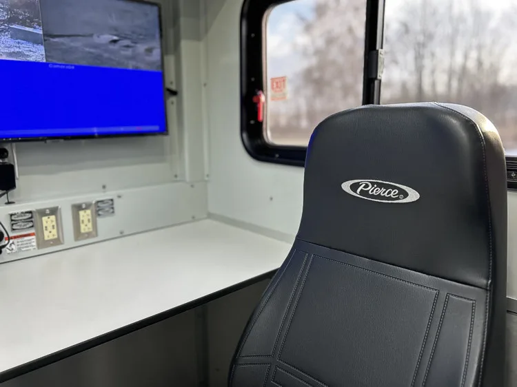Command seat and desk view with monitor and side window