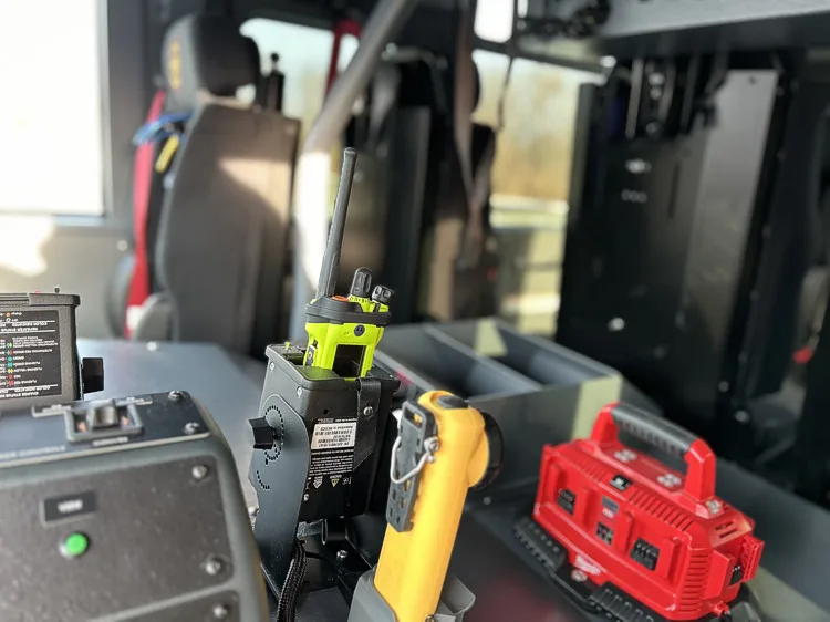 Cab console detail showing portable radios and battery charger units