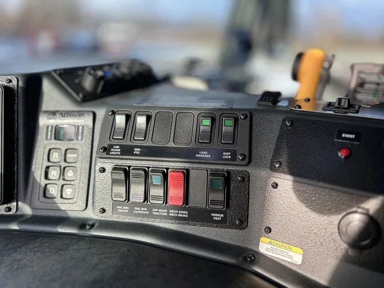 Dashboard switch bank close-up with labeled rocker controls