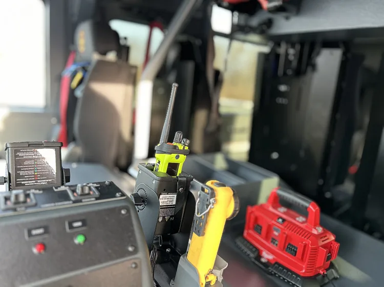 Cab console close-up with portable radios and charging base