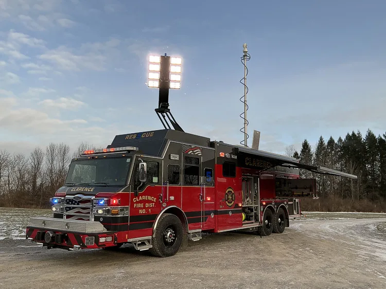 Front-left exterior view showing chrome grille, bumper, and cab