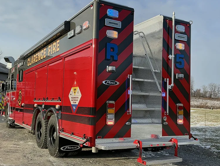 Rear view showing red-and-black chevrons and center access stair