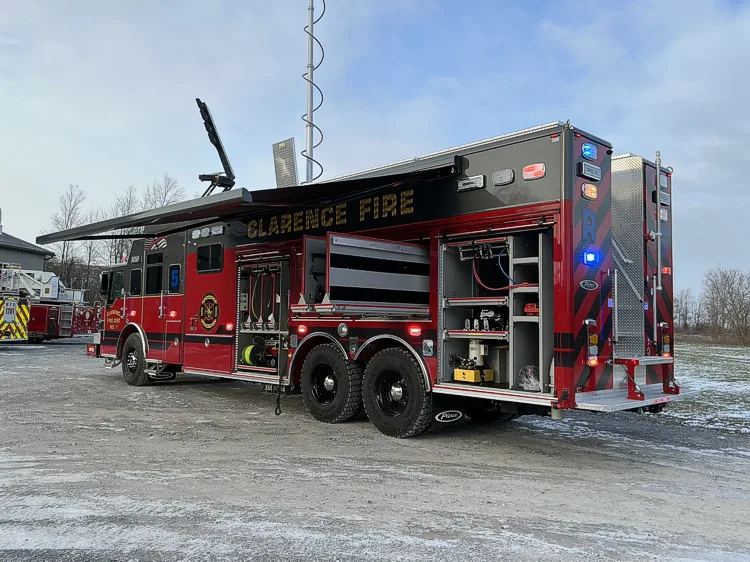Rear-left exterior view showing open compartments and rear chevrons