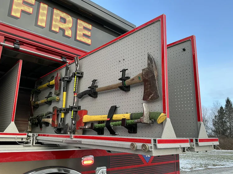 Driver-side view with open compartments and equipment bays