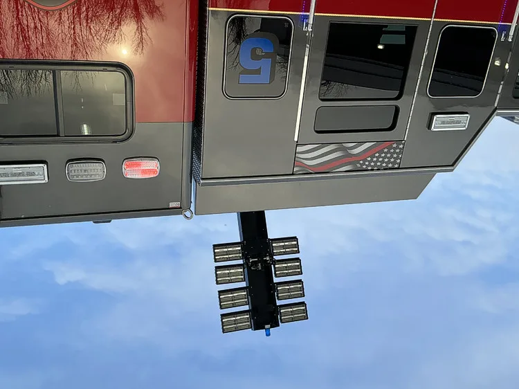 Underside view of rear tiller cab showing scene light cluster and lower body