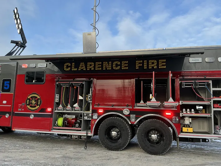 Rear-left exterior view showing tandem axles and open side compartments