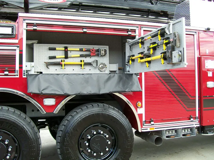 Open side compartment showing pull-out long-tool rack and storage channel