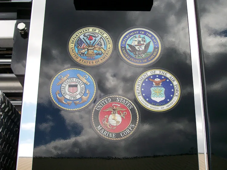 Cab window close-up showing multiple department emblems and decals