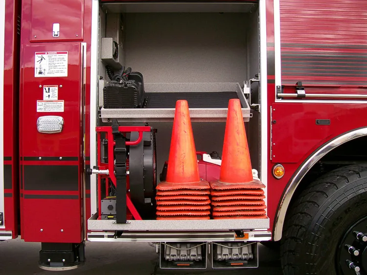 Open side compartment showing traffic cones and vertical storage bay