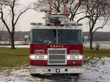 Front exterior view showing grille, bumper, and ladder base above cab