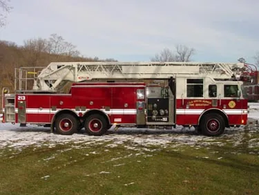 Passenger-side full profile showing extended wheelbase and ladder bed