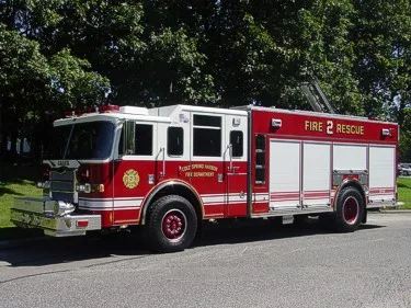 Driver-side profile view showing long body and side rescue compartments