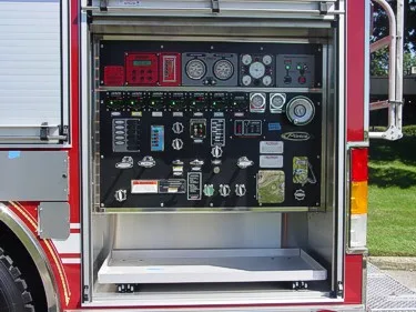 Pump panel close-up showing gauges, valves, and control levers