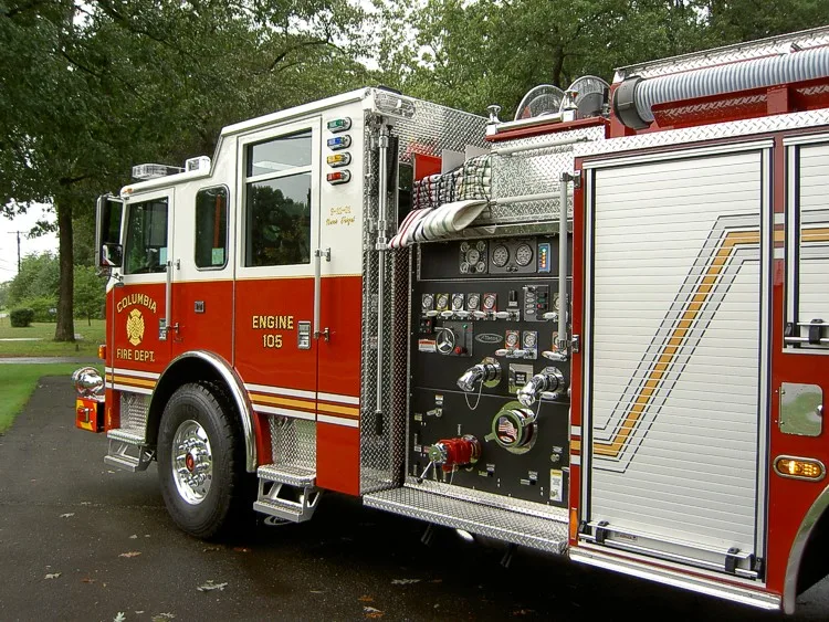 Driver-side pump panel close-up showing gauges, valves, and hose connections
