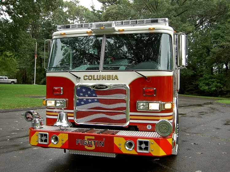 Front exterior view showing grille, bumper, and warning lights