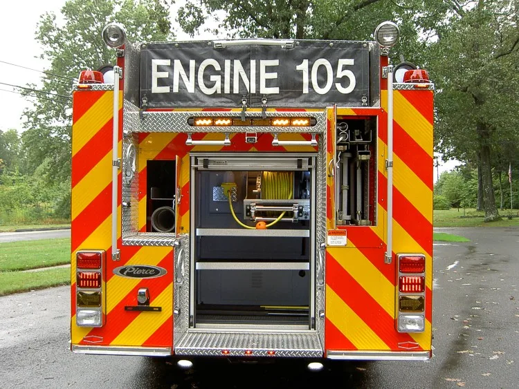 Rear view with lower compartment open showing hose reel and storage area