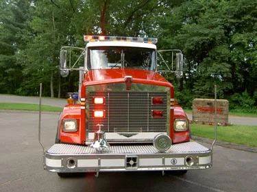 Front exterior view showing grille, bumper, and warning lights