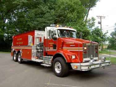 Front-right exterior view showing cab, side tank body, and wheel area
