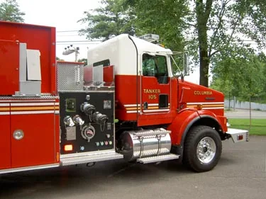 Driver-side cab and pump panel view showing gauges, valves, and controls