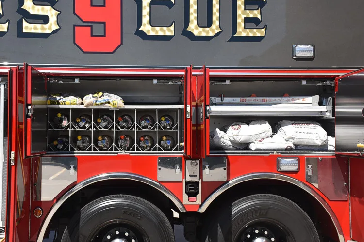 Open side compartment showing mounted rescue tools and organized equipment racks