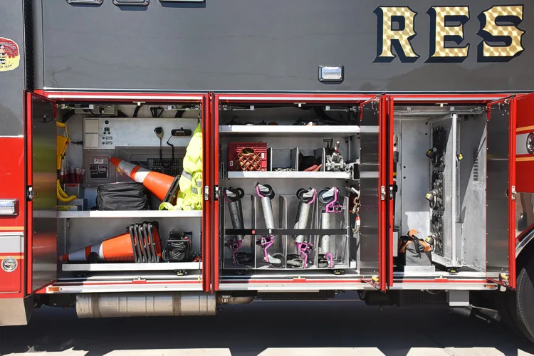 Open long side compartment showing mounted hand tools and rescue equipment