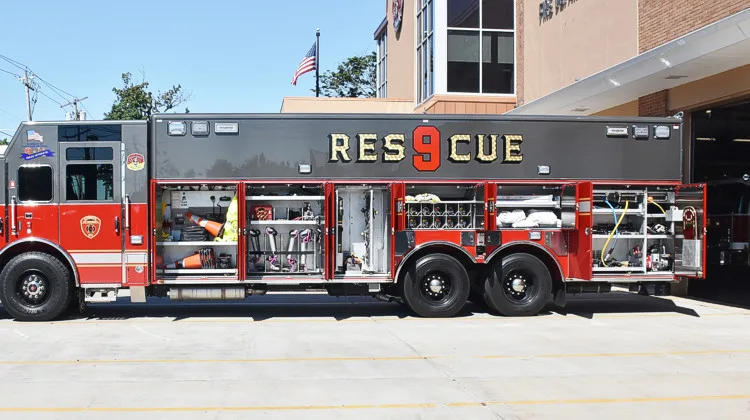 Heavy rescue truck side profile view showing full body and rear wheel set