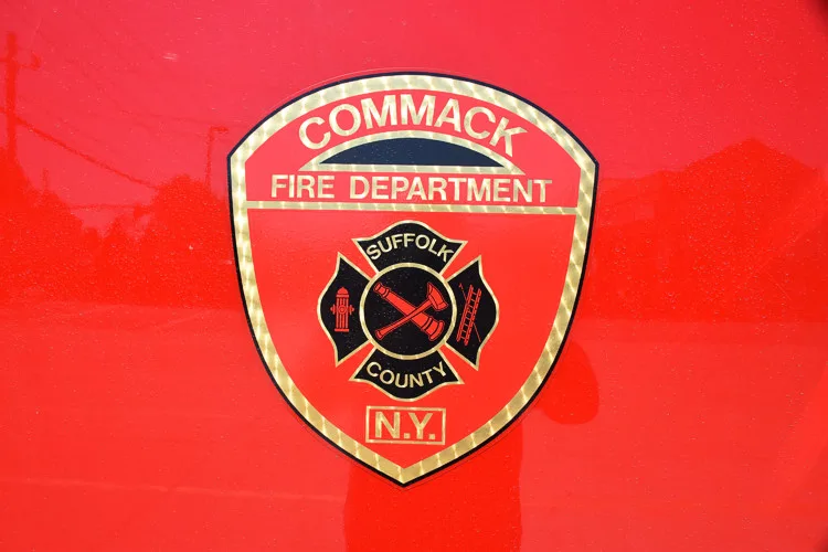 Cab door close-up showing circular department crest on red paint