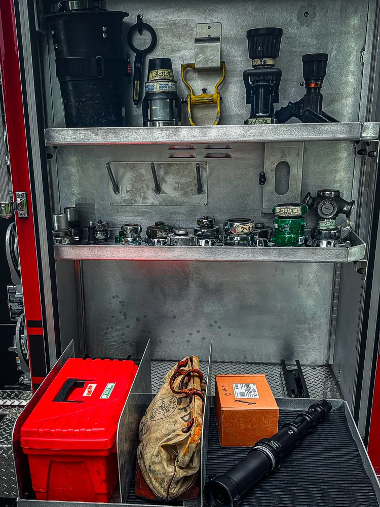 Open side compartment showing shelves with glassware and small equipment containers