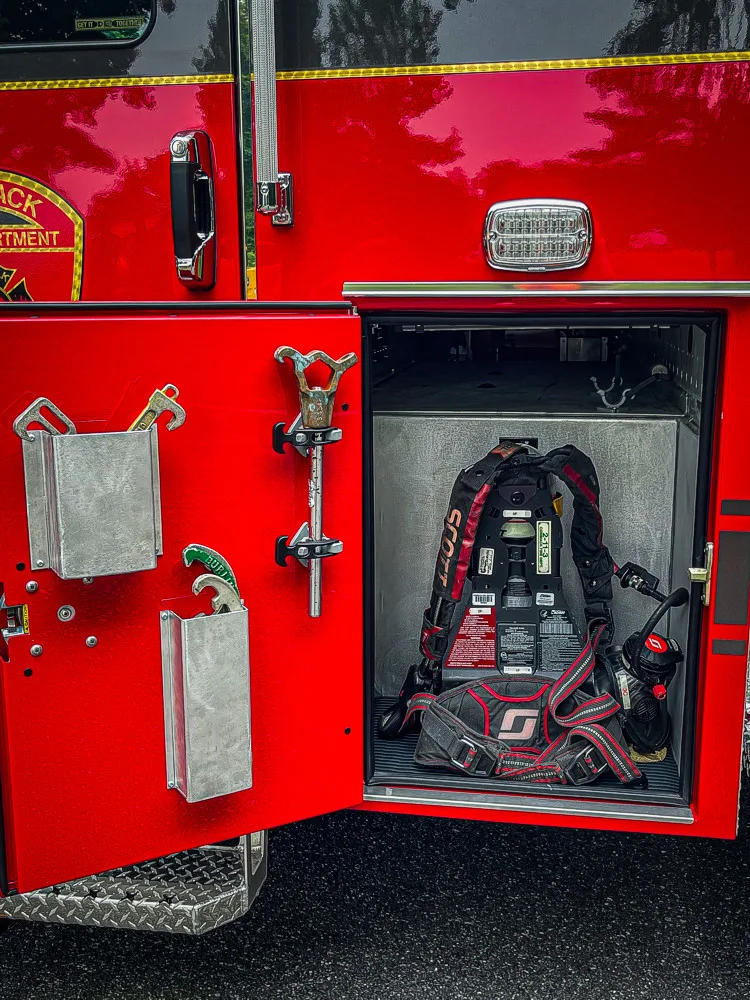 Open side compartment showing pump plumbing and intake connection hardware