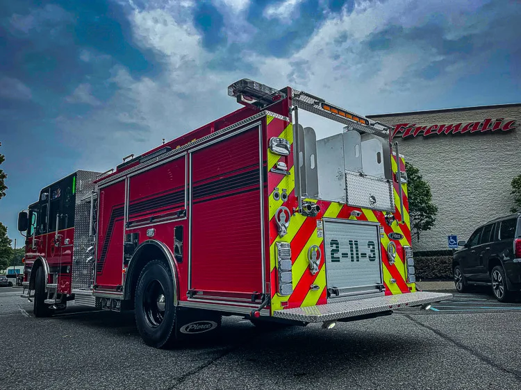 Rear-left exterior view showing chevrons and rear body section